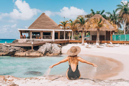 woman on the mexican beach on Cozumal is watching the caribbean seaの写真素材