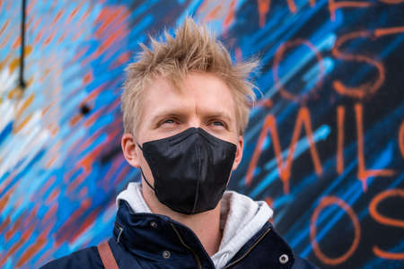European man travel wearing black face protection agains coronavirusの写真素材