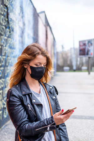 European woman travel wearing face protection agains coronavirusの写真素材