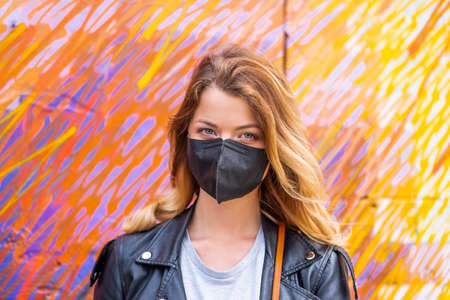 European woman travel wearing black face protection agains coronavirusの写真素材