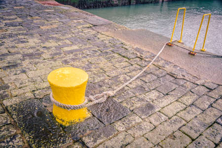 Yellow bollard at the old harbor of dunbar, scottlandの写真素材