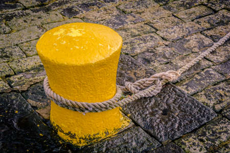Yellow bollard at the old harbor of dunbar, scottlandの写真素材