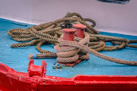 Red bollard on board at the old harbor of dunbar, scottlandの写真素材