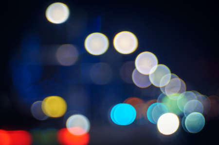 Evening traffic. The city lights. Motion blur and bokeh effect viewed from the road