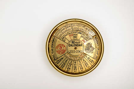 everlasting calendar old golden diary almanac isolated on white backgroundの写真素材