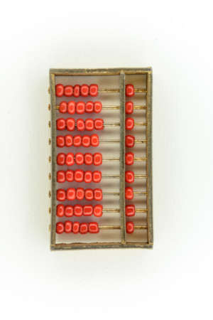 abacus of many red beads in gold on white backgroundの写真素材