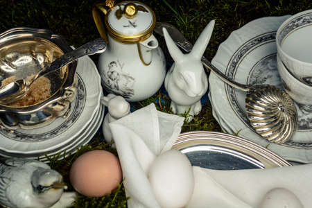 Served for Easter meal old table with plates, eggs and candles, selective focusの写真素材