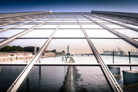 Office building in Hamburg and river same in the background photography of Hamburg district at Hamburg harbor in sunlightの写真素材