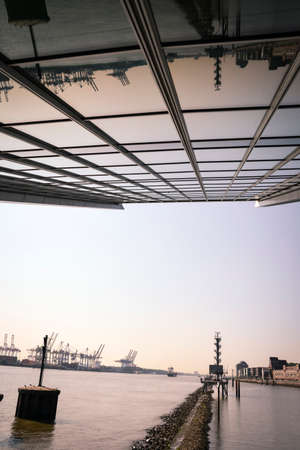 Office building in Hamburg and river same in the background photography of Hamburg district at Hamburg harbor in sunlightの写真素材