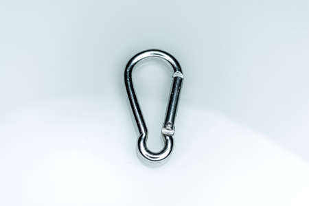 close up shot of gray aluminum carabiner isolated on a white backgroundの写真素材