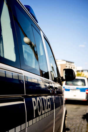 flashing lights of a German police car into the checkpoint in the city at daylightの写真素材