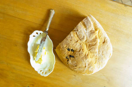 Top view of bread with butter on white table