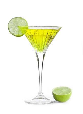 yellow alcoholic cocktail with a slice of limeの写真素材
