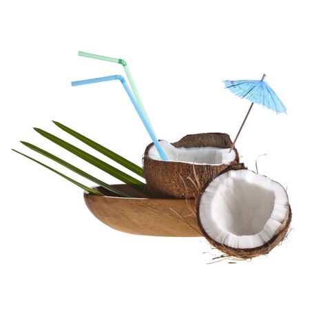 coconut cocktail with straw and umbrella in wooden bowl の写真素材