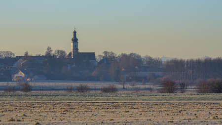 village with church in a bright morning lightの写真素材
