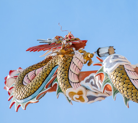 golden dragon wrap wood pillarの写真素材