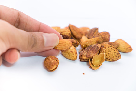 Dried almonds with shell on a white backgroundの写真素材