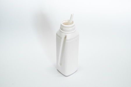 Open white bottle on white backgroundの写真素材