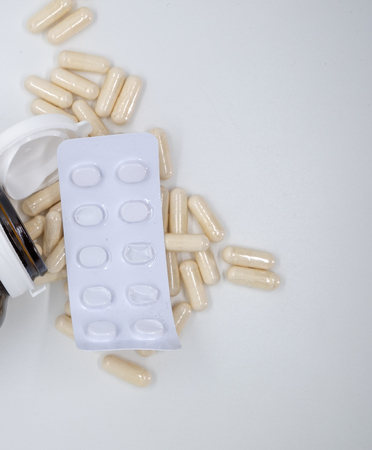 Assorted pharmaceutical medicine pills, tablets and capsules and bottle