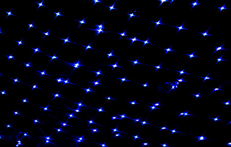 Blue lights bokeh on the ceiling of a building in the night. Abstract background for design.