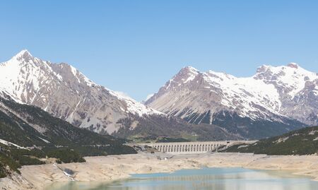 hydroelectric site on Alps with dam and artificial lake