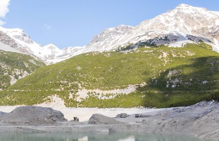 hydroelectric site on Alps with dam and artificial lake