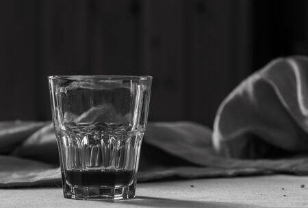 A table with a small glass in a wooden refugeの写真素材