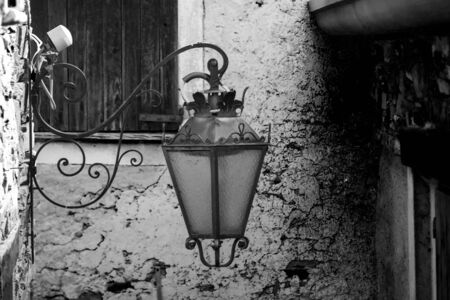 Old street lamp in an alley of a mountain townの写真素材