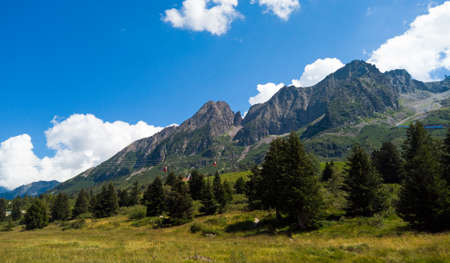 Alpine panorama in summer time, sunny day on a mountain trailの写真素材