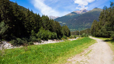 Alpine panorama in summer time, sunny day on a mountain trailの写真素材