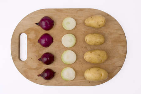 onion and potatoes on wooden boardの写真素材