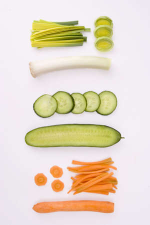 sliced cucumber, leek and carrot on white backgroundの写真素材
