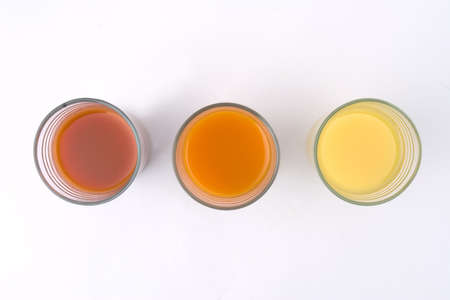 glass of orange tomato and kiwi juiceの写真素材