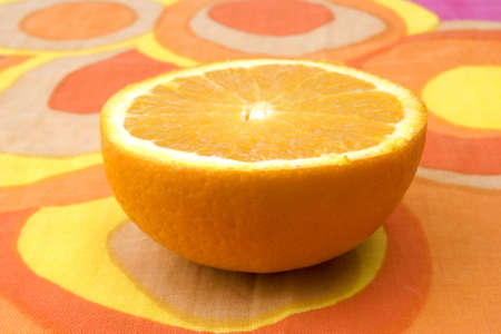 sliced orange on colourful patterned cloth