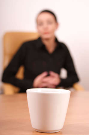 tired woman looking at the glass of water - woman aut of focusの写真素材