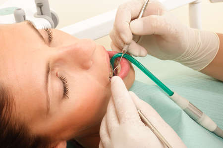 female patient at the dentist - under the treatment