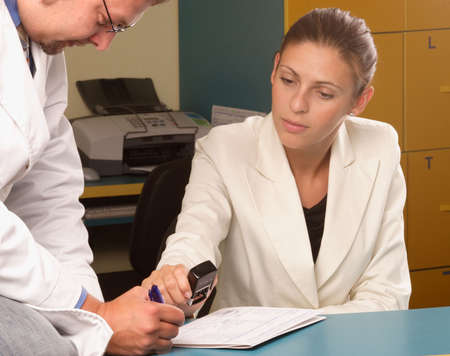Medical secretary and doctor working together in the office
