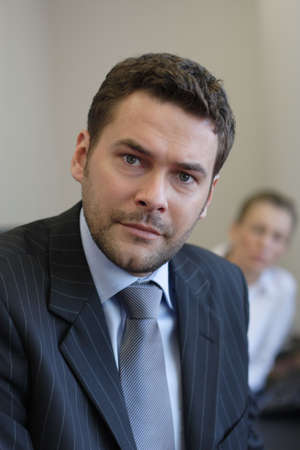 Business partners -  woman out of focus, man  close up