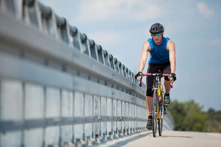 fit cyclist riding on race bikeの写真素材