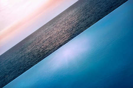swimming pool and ocean water, clouded  sky - shape and color conceptの写真素材