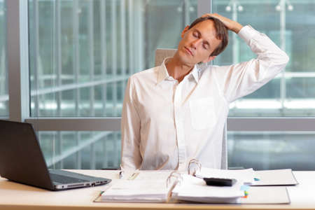 white collar worker male relaxing neck - short break for exercise in officeの写真素材