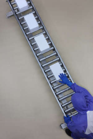 aerial view of worker in blue uniform working with boxes on packing line