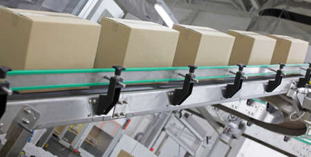 automation - Cardboard boxes on conveyor belt in factory