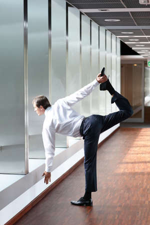 caucasian business man in warrior asana in the office