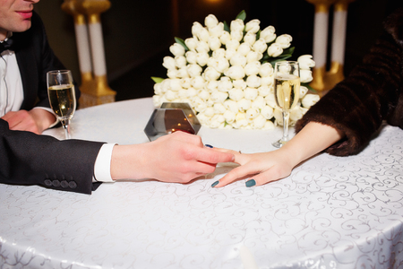 husband and wife holding hands and drinking champagneの写真素材