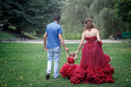 family with child walking in the park in summerの写真素材