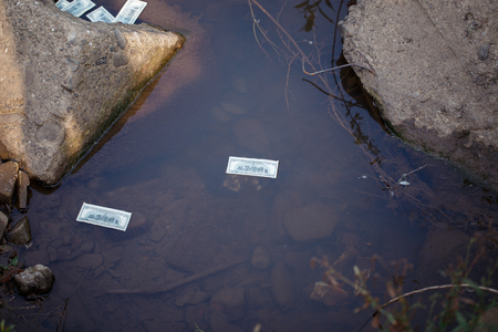 Money thrown into the waterの写真素材