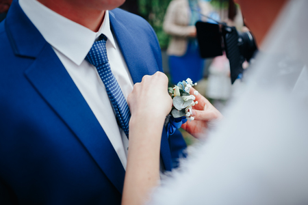 bride gives the groom a beautiful flowerの写真素材