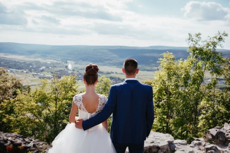 bride and groom looking at mountainsの写真素材