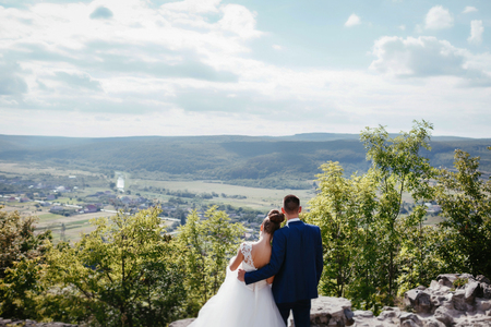 bride and groom looking at mountainsの写真素材